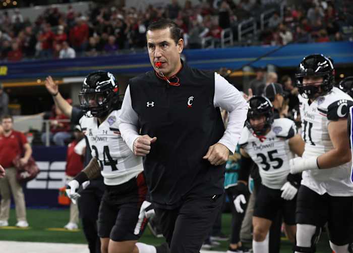 Dec 31, 2021; Arlington, Texas, USA; Cincinnati Bearcats head coach Luke Fickell takes the field with his team prior to the game against the the Alabama Crimson Tide during the 2021 Cotton Bowl college football CFP national semifinal game at AT&T Stadium. Mandatory Credit: Matthew Emmons-USA TODAY Sports
